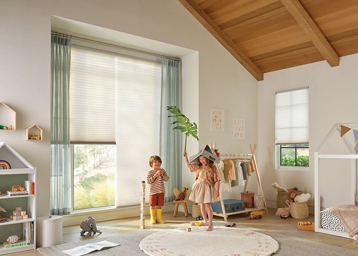 Bright, energy-efficient window blinds with light-filtering roller shades in a child's bedroom, providing privacy and style.