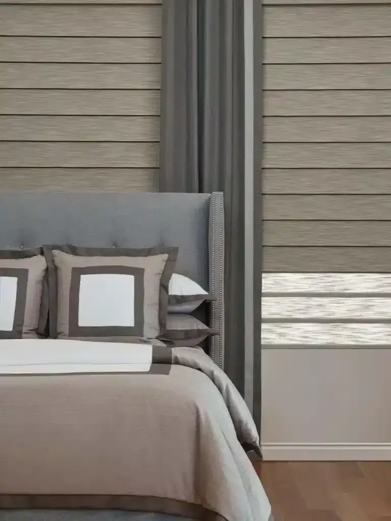 Luxurious bedroom with stylish window treatments including blinds and drapery, featuring neutral tones and modern decor for an elegant and comfortable space.