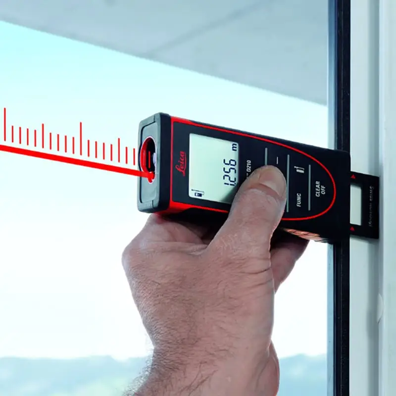 Laser measurement tool measuring window dimensions for custom blinds and drapery products.
