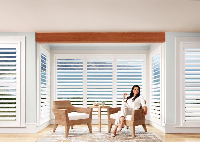 Sliding window shutters with white blinds, modern window treatments, home with custom blinds, advance blinds & drapery, stylish window coverings for living room.