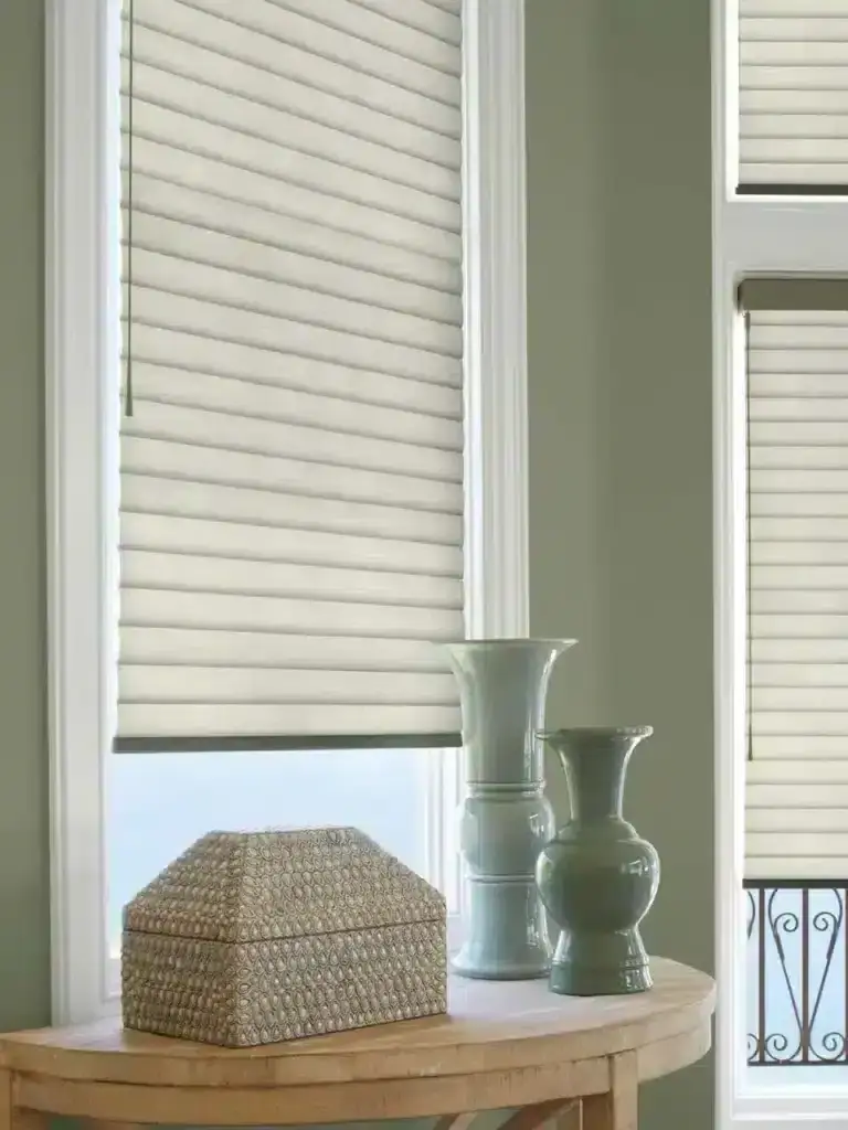 Luxurious beige Roman window blinds providing elegant light control and privacy for home interiors. Customizable window treatment solutions by Advance Blinds & Drapery.