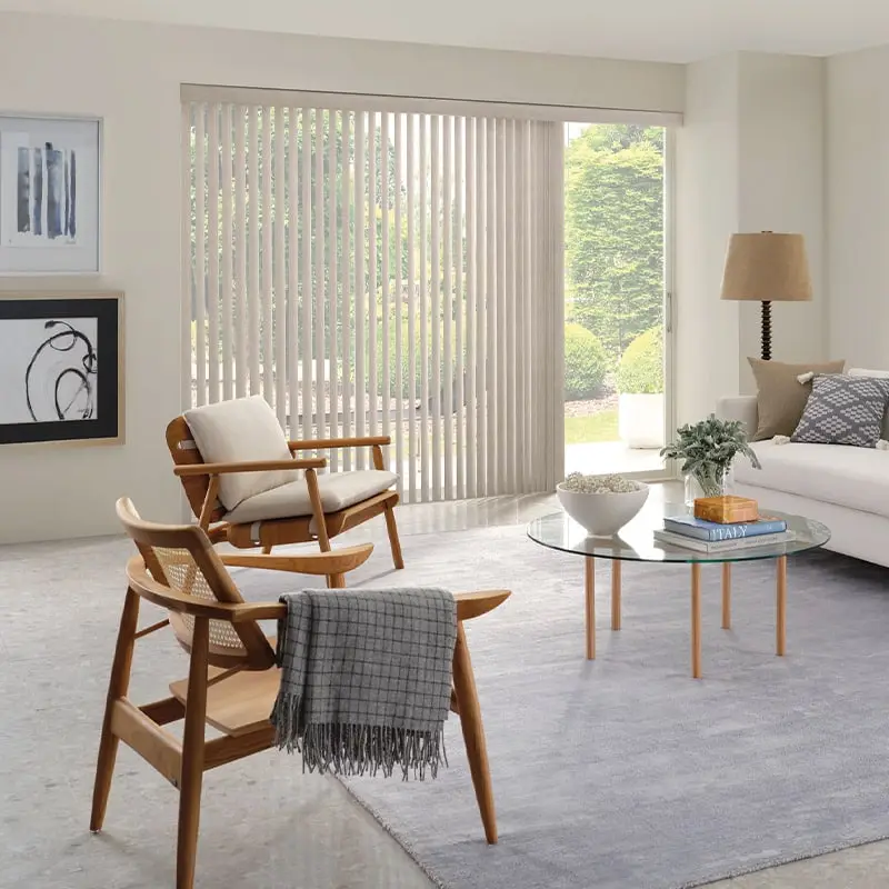 Luxurious living room with custom vertical blinds, modern furniture, and natural light, showcasing premium window treatments by Advance Blinds & Drapery.