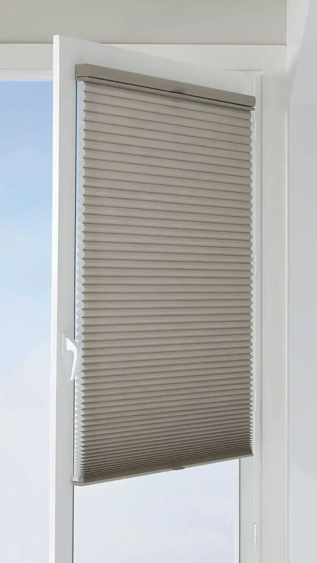 Elegant beige cellular shade window treatment offering light control and privacy, perfect for custom blinds, shades, and drapery solutions by Advance Blinds & Drapery.