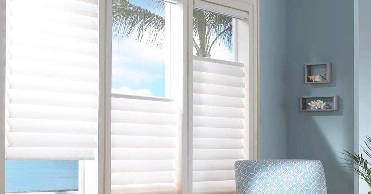 Custom exterior UV protection window shades in a bright coastal home.