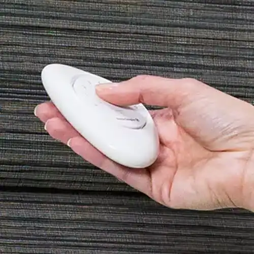 Remote control for window blinds and drapery shades, cordless design for safety and ease of use.
