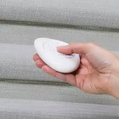 Bright, modern remote control used for adjusting window blinds or curtains, displayed against a contemporary textured wall. Perfect for easy home automation and window treatment management.