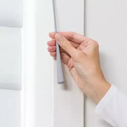 New window blinds being installed with a hand tool for smooth operation, showcasing quality window treatment installation services by Advance Blinds & Drapery.