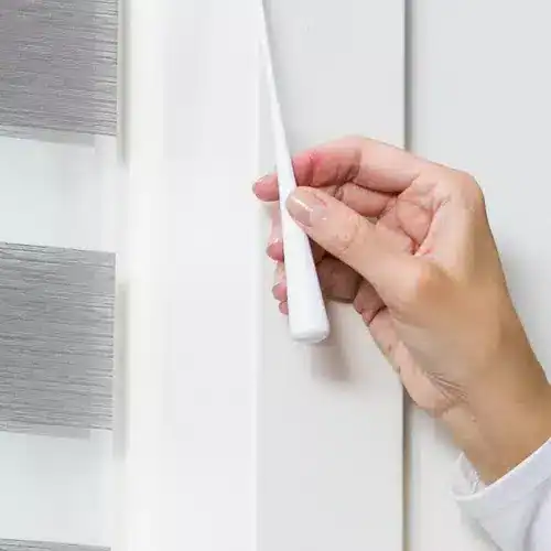 Magnetic cordless window blind installation for modern, sleek shading solutions.