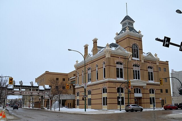 Elegant historic building on a snowy city street showcasing classic architecture for Premium Drapery and Interior Window Coverings.