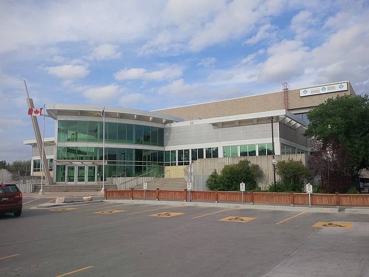 Modern medical or research facility with glass facade and accessible parking.
