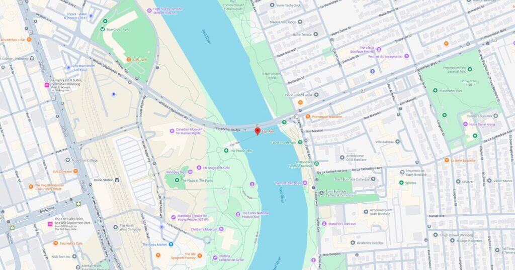 Map of riverfront park showing walking trails, green areas, and nearby landmarks.